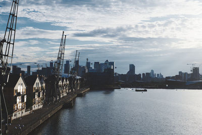 Bridge over river amidst buildings in city of london against sky