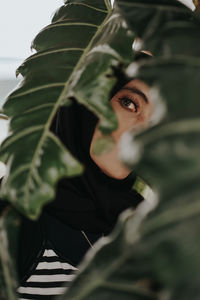 Portrait of woman seen through leaves