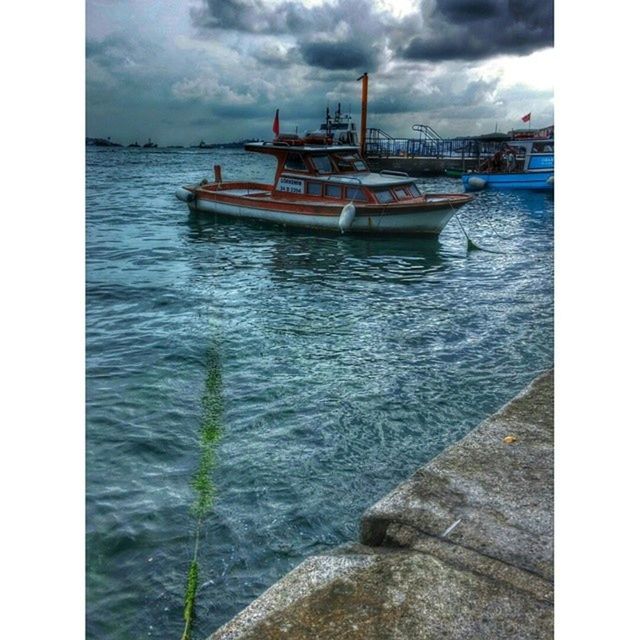 water, nautical vessel, sky, sea, transportation, transfer print, boat, cloud - sky, mode of transport, moored, auto post production filter, cloudy, cloud, tranquility, waterfront, pier, rippled, nature, tranquil scene, harbor