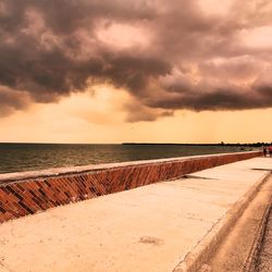 Scenic view of beach against sky during sunset