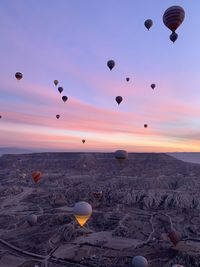 Hot air balloons flying over rocks