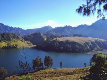 Scenic view of lake and mountains against sky