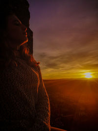 Woman against sky at sunset