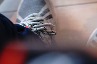 Close-up of man holding shoes