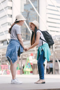 Woman walking with umbrella in city