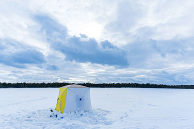 Scenic view of snow covered field against sky