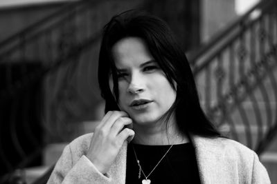 Portrait of young woman looking away outdoors