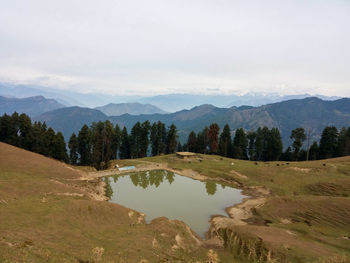 Scenic view of landscape and mountains against sky