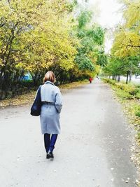 Rear view of women walking on road