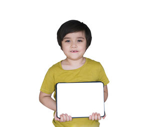 Portrait of boy holding smart phone against white background