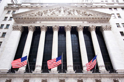 Low angle view of flags against building