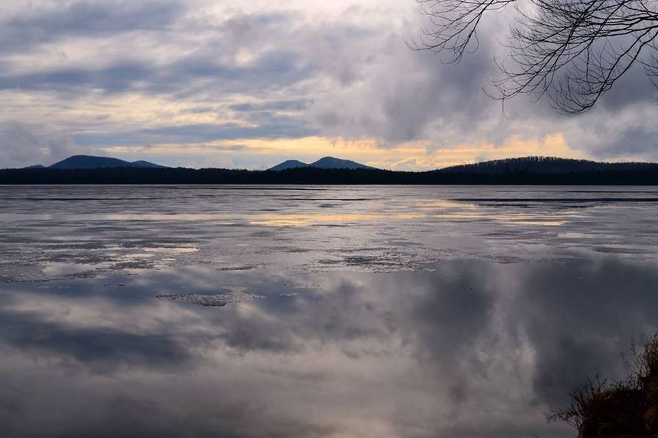 mountain, sky, water, tranquil scene, cloud - sky, scenics, tranquility, beauty in nature, mountain range, lake, cloudy, reflection, nature, weather, cloud, idyllic, waterfront, winter, dusk, cold temperature