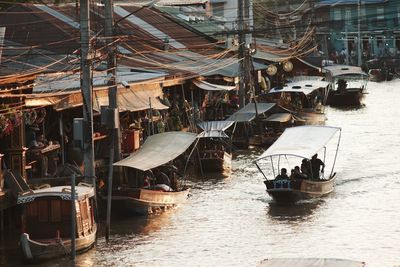 Sailboats moored on harbor in city