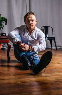 Portrait of young man sitting on chair