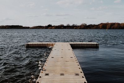 Empty jetty leading to rippled sea