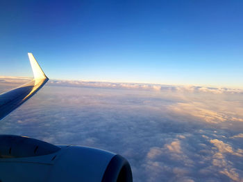 Aerial view of cloudscape over airplane wing