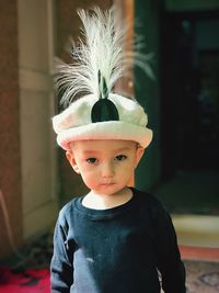 Portrait of cute boy wearing headwear at home