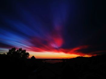 Scenic view of silhouette landscape against sky at sunset