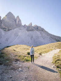 Rear view of woman looking at rock mountain