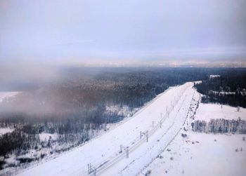 Aerial view of snow covered mountain against sky