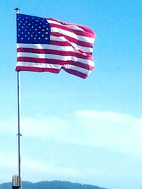 Low angle view of american flag against sky