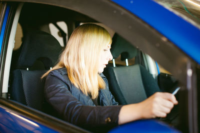 Close-up of woman sitting in car