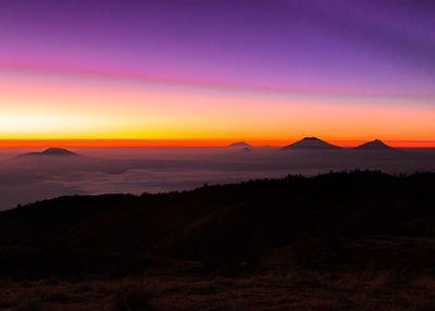 Scenic view of silhouette mountains against sky during sunset