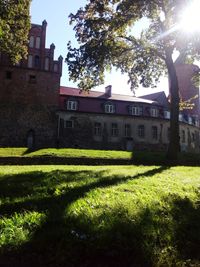 Lawn by building against sky