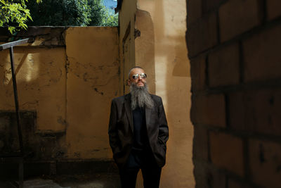 Young man standing against wall