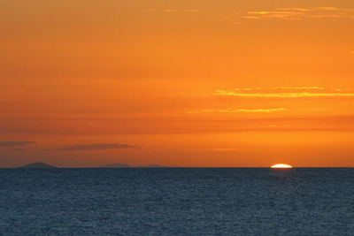 Scenic view of sea against orange sky