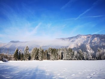 Panoramic view of snow covered mountains against sky