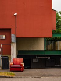 Empty seats on street against building