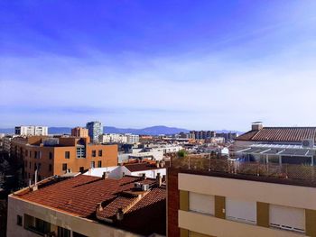 High angle view of townscape against blue sky