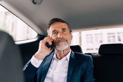 Midsection of man using mobile phone