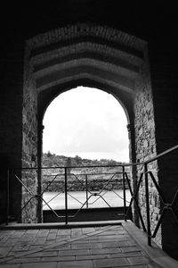 Bridge over sea against sky seen through window