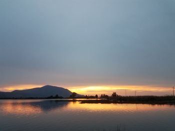 Scenic view of lake against sky during sunset