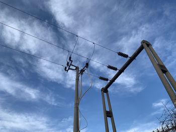 Low angle view of electricity pylon against sky