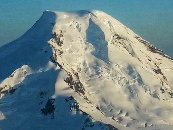 Scenic view of snow covered mountains against sky