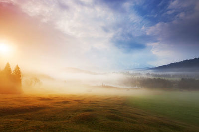 Scenic view of landscape against sky during sunset