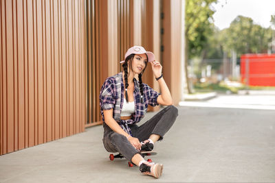 Side view of young woman using mobile phone