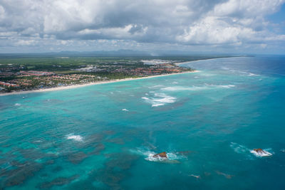 Aerial view of calm sea against cloudy sky