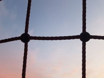 Close-up of metal fence against sky