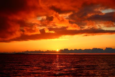 Scenic view of sea against romantic sky at sunset