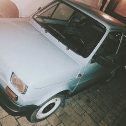 High angle view of abandoned car on street in city