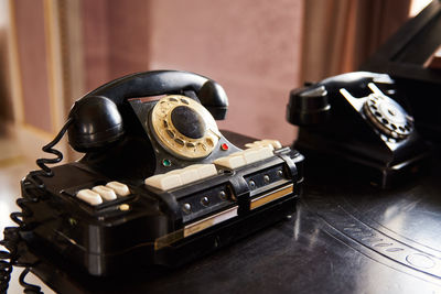 Vintage black phone on the table. retro office
