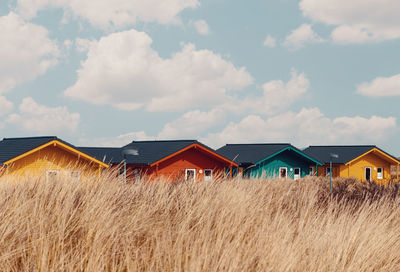 Houses on field against sky