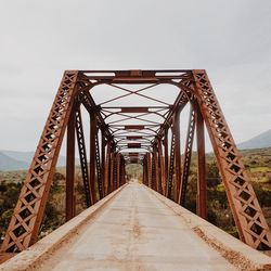 Metallic bridge against sky