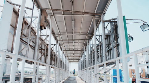 Low angle view of people walking on footpath amidst buildings