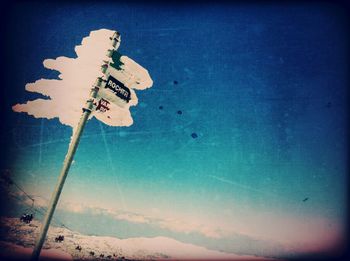 Low angle view of street light against blue sky