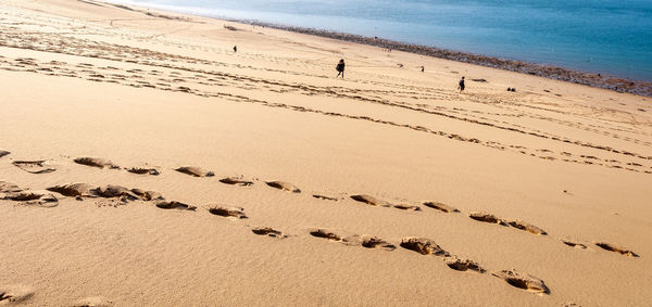 High angle view of footprints on beach